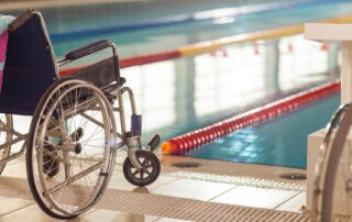 Wheelchair user at swimming pool. Maintaining heart health with spinal cord injury. Propel Physiotherapy