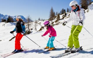 family skiing in protective gear preventing concussions winter sports winter weather