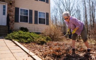 Woman doing spring clean up. How to safely return to activity after a break. Propel Physiotherapy