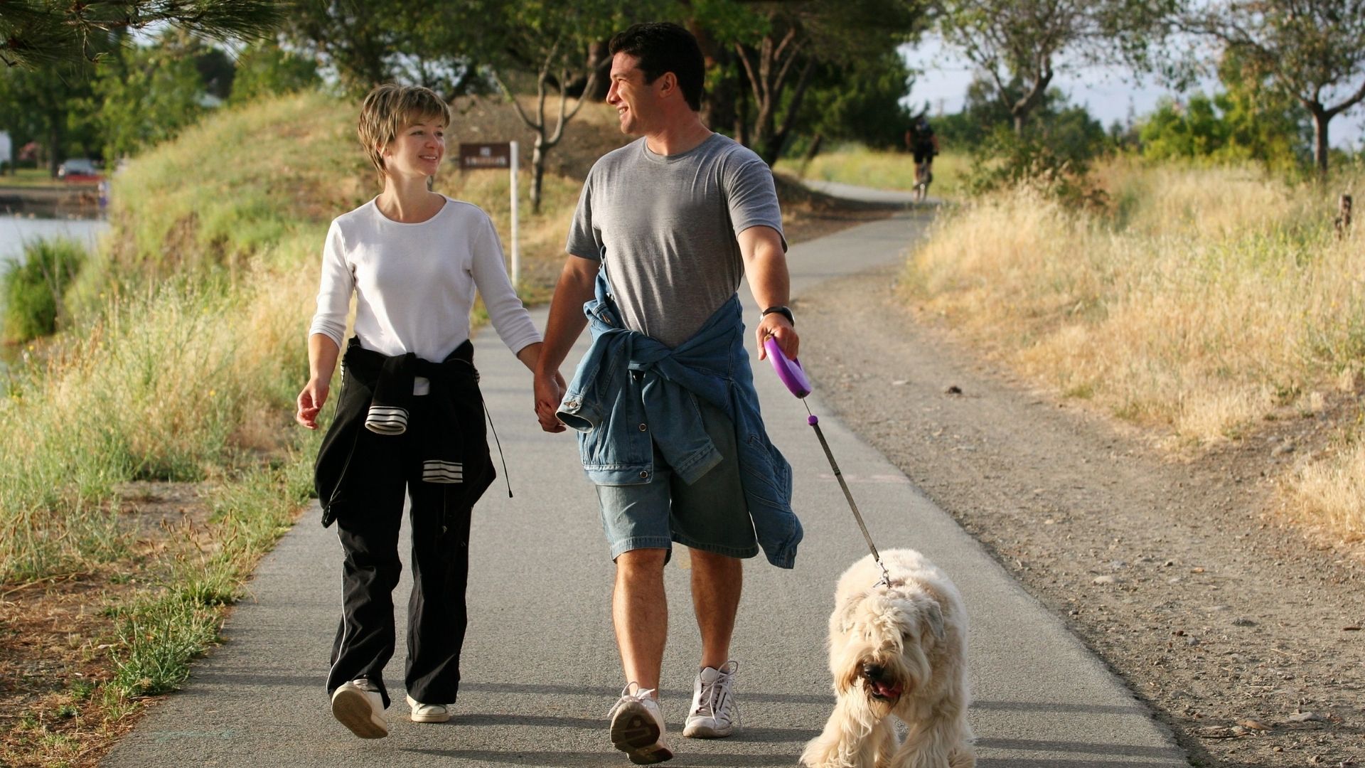 Couple walking their dog on a trail. Benefits of walking Propel Physiotherapy