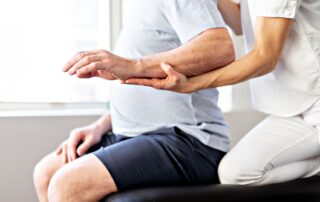 Physiotherapist guides clients hand to target. Ideomotor apraxia treatment Propel Physiotherapy.