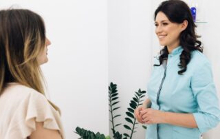Woman talking to physiotherapist about functional neurological disorder treatment at Propel Physiotherapy.