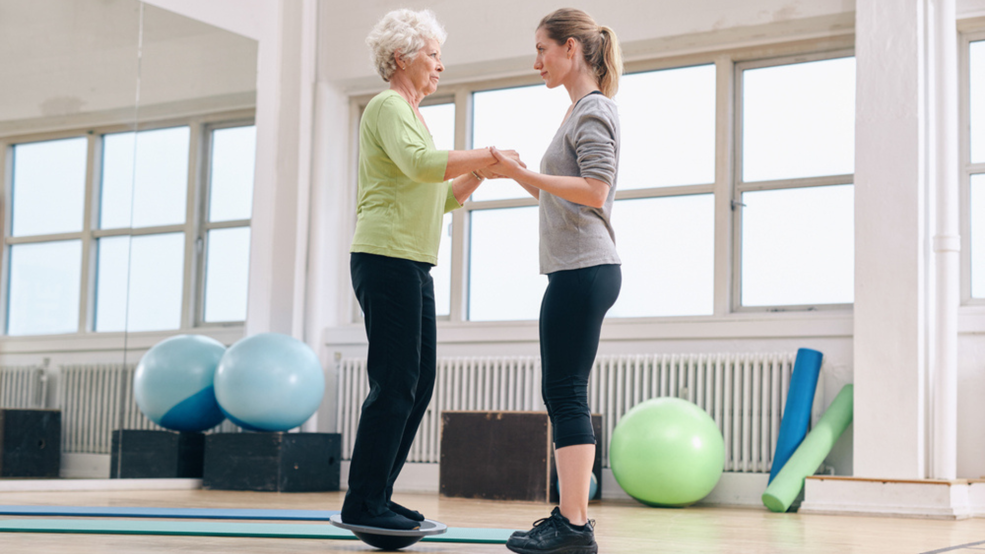 Physiotherapist working with elderly woman with multiple sclerosis on balance training. Multiple sclerosis symptoms management Propel Physiotherapy.