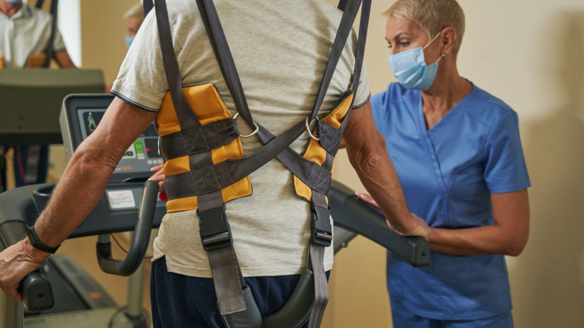 Man walking on treadmill wearing body weight support harness during physiotherapy session. Treadmill training to improve walking after stroke. Stroke rehabilitation at Propel Physiotherapy.