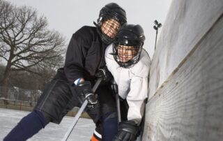 Youth hockey player bodychecking opponent into boards. Chronic traumatic encephalopathy (CTE) risk. How to prevent concussion in youth hockey. Concussion management Propel Physiotherapy.