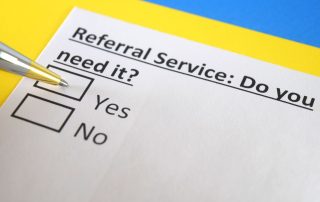 Referral note that has "Referral Services: Do you need it?" written on it. There are two check boxes for "yes" and "no". A pen is positioned in the yes box. Six evidence-based reasons physiotherapists refer you to massage therapy at Propel Physiotherapy.