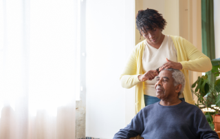 Woman grooming her elderly father at home. Mindfulness strategies to combat caregiver burnout. Propel Physiotherapy.