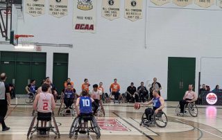 A group of wheelchair basketball players on the court. Wheelchair basketball: rules, how to train and injury prevention strategies from Propel Physiotherapy.